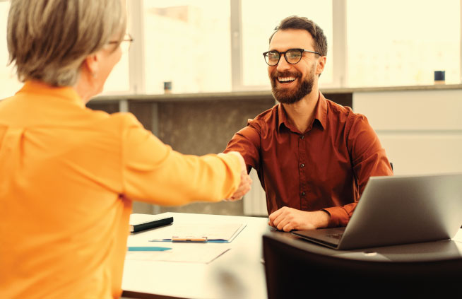 Image of two people discussing reinsurance options