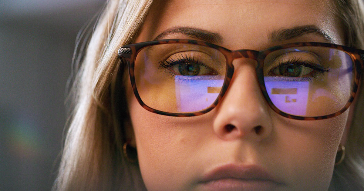 AI reflecting in woman's glasses