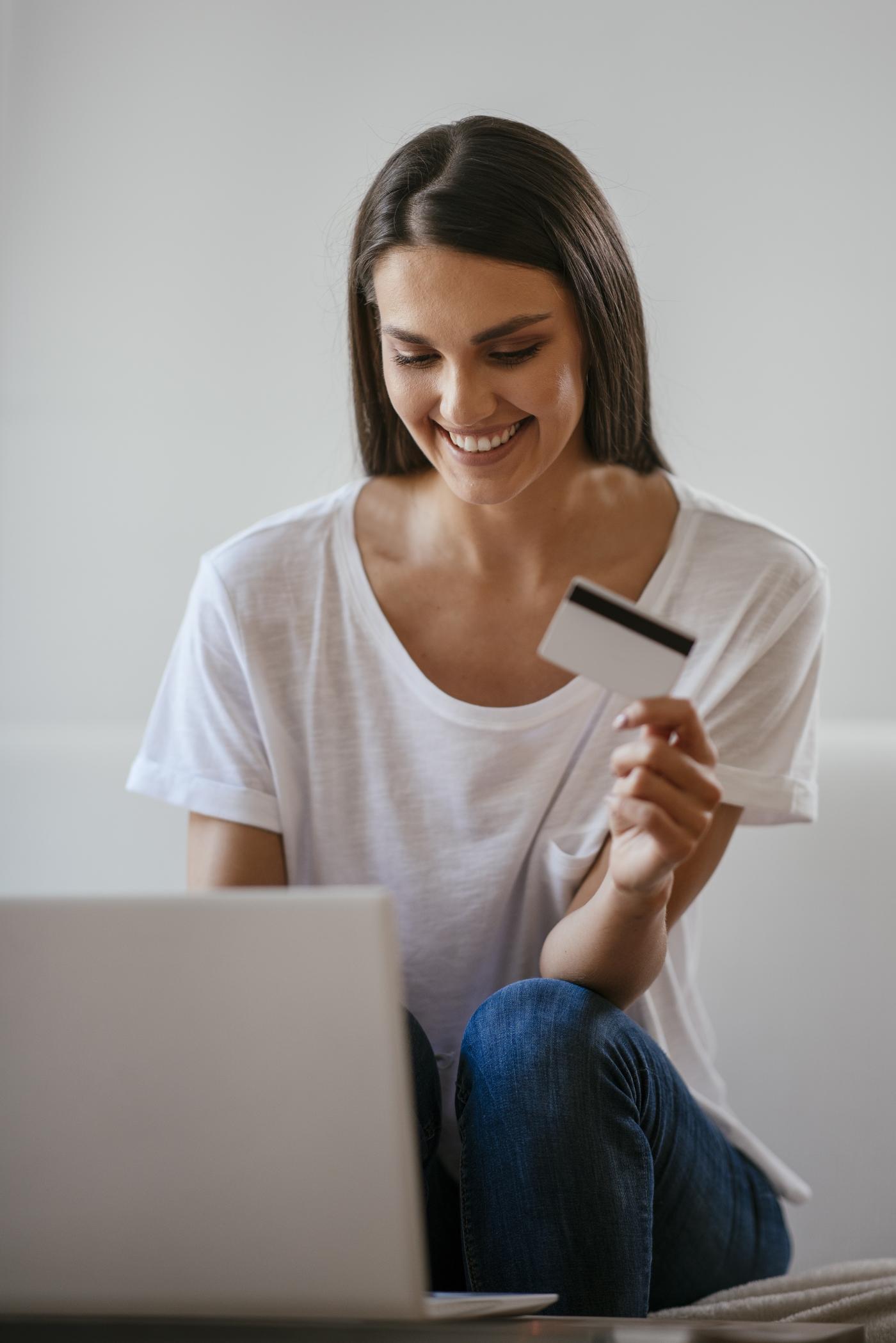 a woman holding a credit car to symbolize easy payments